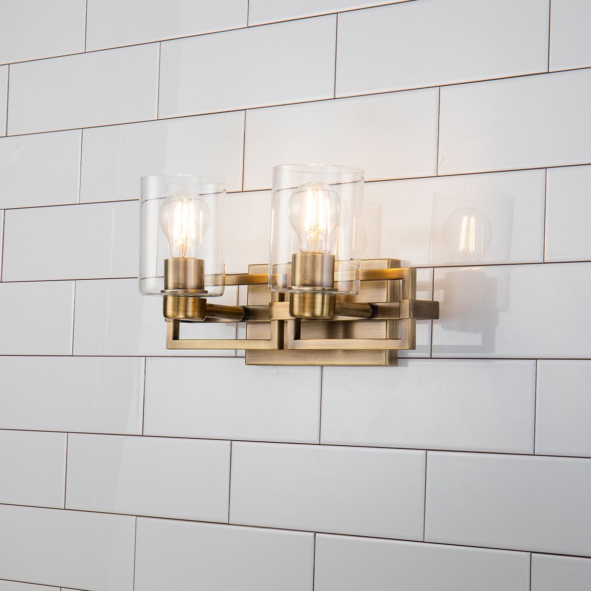 Lucas & McKearn Estes 2-Light Antique Brass Wall Light With Cylinder Shape Clear Glass Shade