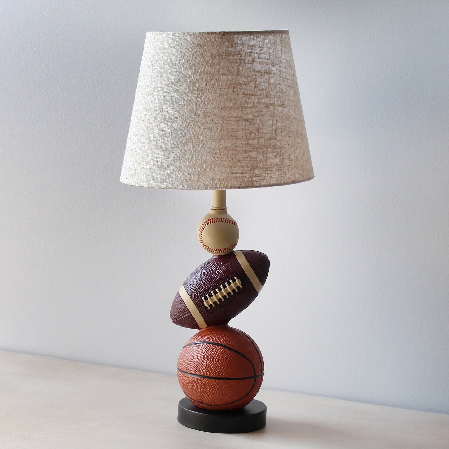 All The Rages Simple Designs SportsLite White 22" Tall Popular Sports Combo Basketball, Baseball, Football Polyresin Table Lamp With Light Beige Tapered Drum Fabric Shade