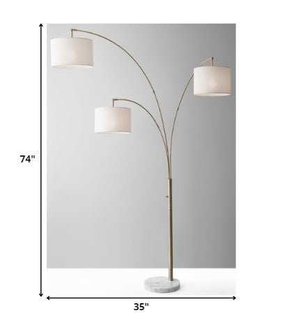 HomeRoots 74" Three Light Floor Lamp With Metal Arc Arms in Antique Brass Finish