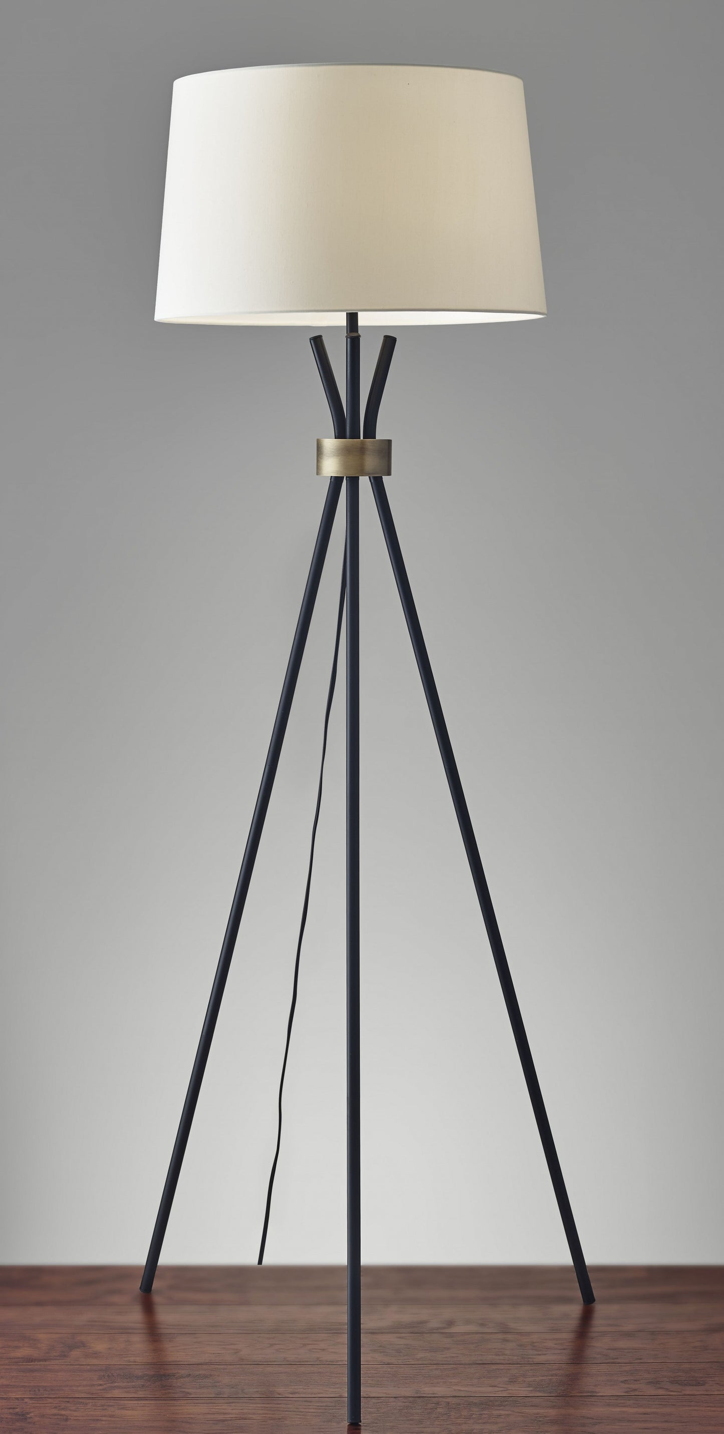 HomeRoots Metal Floor Lamp With Tripod Leg and Antique Brass Accent in Black Finish