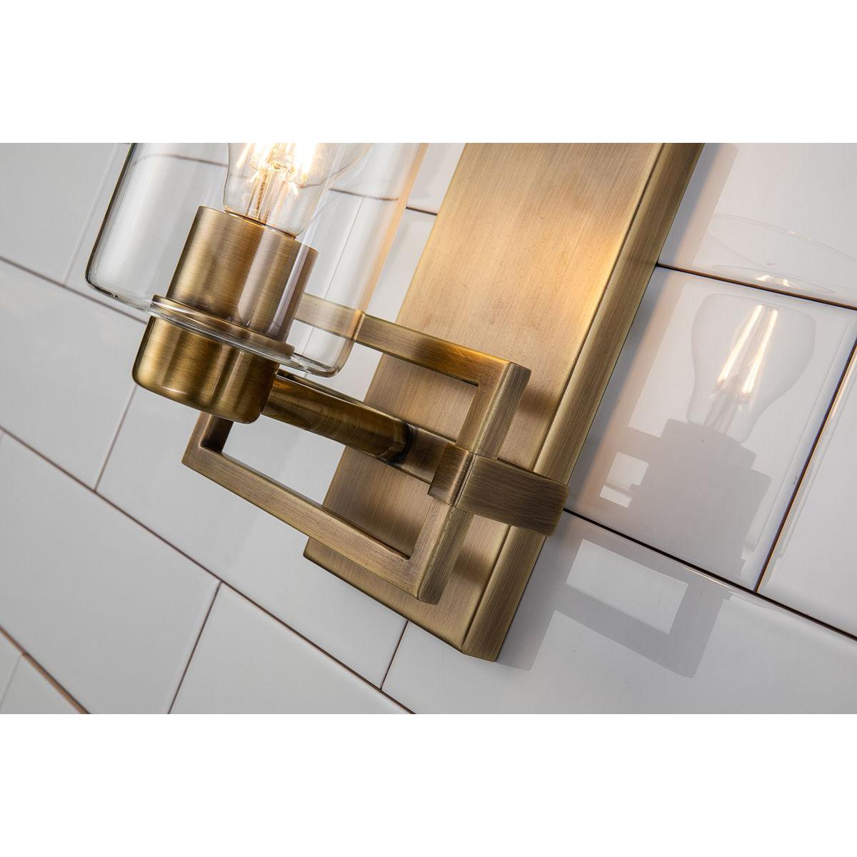 Lucas & McKearn Estes 1-Light Antique Brass Wall Light With Cylinder Shape Clear Glass Shade