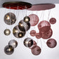 Meyda Lighting Bola 40" 9-Light Brown Metallic Plush Cascading Pendant Light With Smoke Idalight Shade Glass