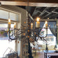 Stone County Ironworks Garden Gate 36" 5 Arm Hand Rubbed Brass Iron Chandelier With Pewter Iron Accent and Ivory Drip Cover