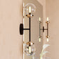 Vaxcel Orbit 2-Light Brass and Oil Rubbed Bronze Industrial MCM Wall Sconce Clear Glass Globe