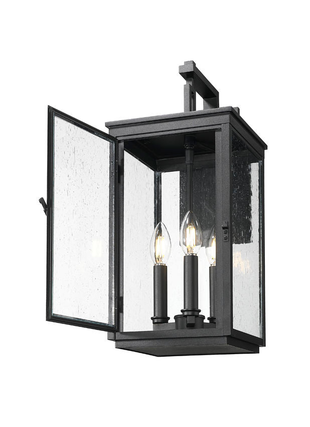 Z-Lite Hartwell 3-Light Candelabra Sand Black Aluminum Frame Clear Seedy Glass Shade Outdoor Wall Light