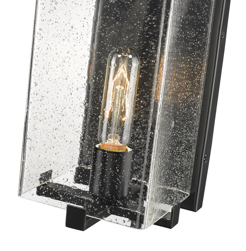 Z-Lite Sana 6" 1-Light Black Aluminum Outdoor Wall Sconce With Seedy Glass Shade