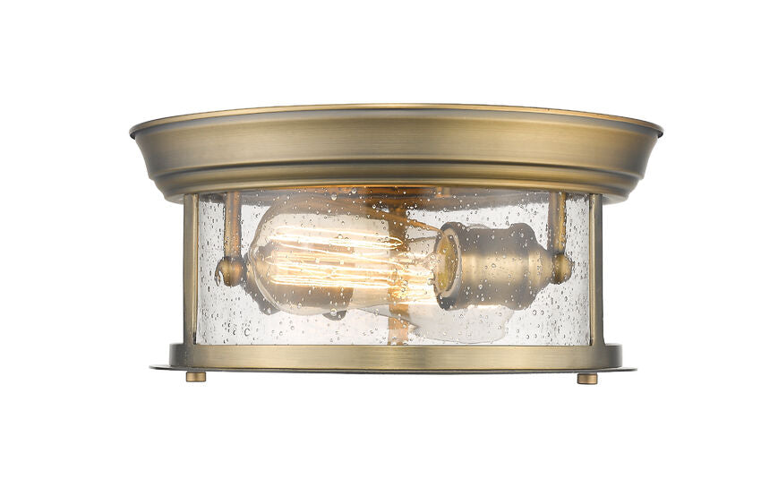 Z-Lite Sonna 11" 2-Light Heritage Brass Flush Mount Lighting With Clear Seedy Glass Shade