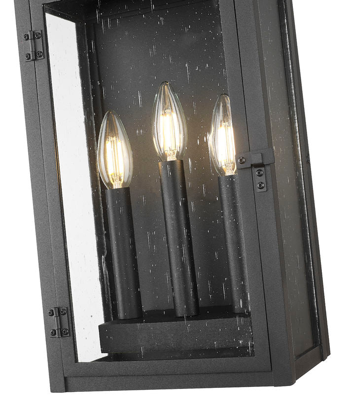 Z-Lite Toulouse 3-Light Candelabra Aluminum and Stainless Steel Sand Black Frame Clear Seedy Glass Shade Outdoor Wall Light